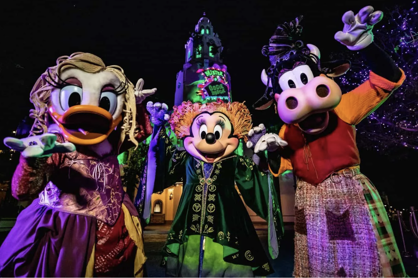 daisy duck, minnie mouse and clarabelle cow dressed up as Sanderson sisters at Oogie boogie